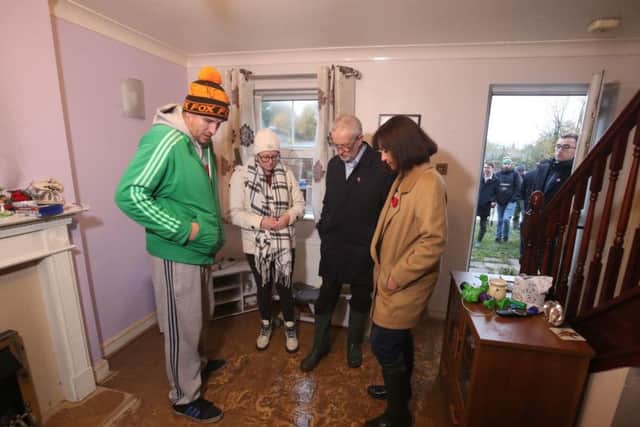 Labour leader Jeremy Corbyn and Labour MP Caroline Flint during a visit to flood victims in Conisborough, South Yorkshire, where he met residents affected by flooding. Picture: Danny Lawson/PA Wire