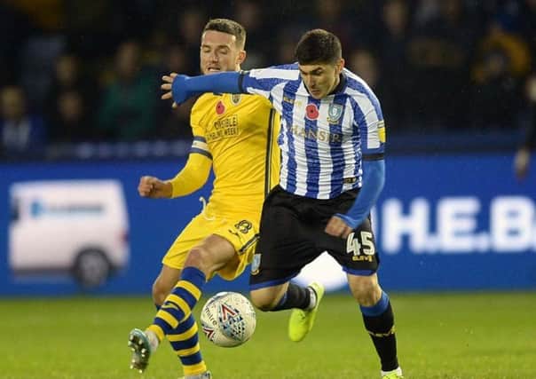 Back in the thick of it: Fernando Forestieri holds off Matt Grimes. Picture: Steve Ellis