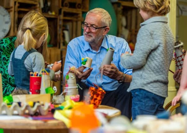 Jeremy Corbyn visits a children's centre in Leeds as he sets out plans to relaunch the Sure Start programme.