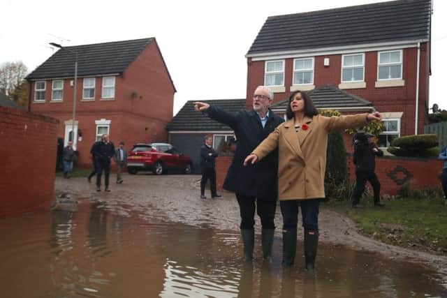 Labour leader Jeremy Corbyn with Labour MP Caroline Flint during a visit to Conisborough, South Yorkshire, where he met residents affected by flooding. Photo: Danny Lawson/PA Wire