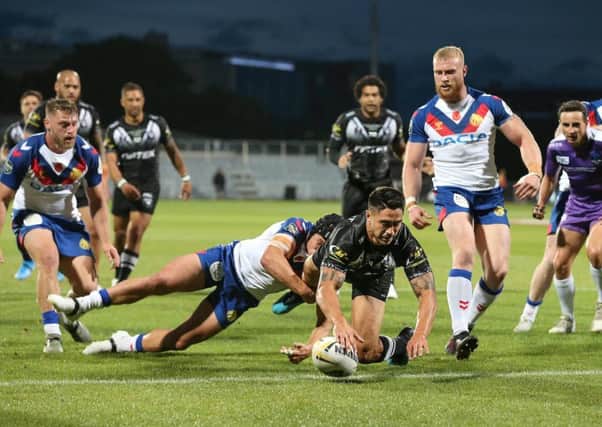 Shaun Johnson dives over for a try.