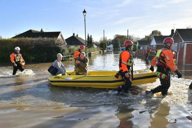 Fire and rescue crews transport people through floodwater to other parts of Fishlake, Doncaster: Ben Birchall/PA Wire
