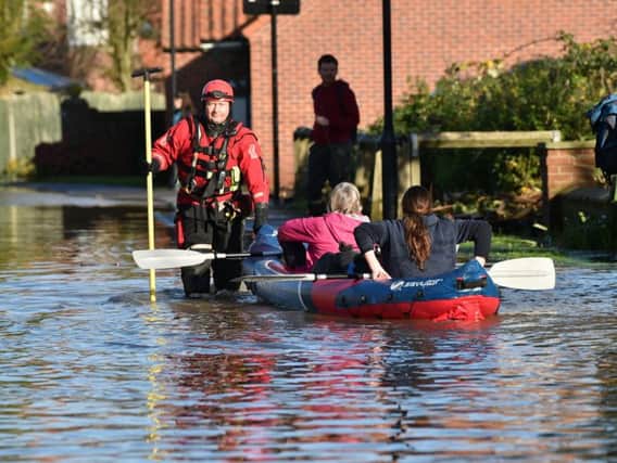 Fire and rescue services help people in a canoe in Fishlake, Doncaster. Ben Birchall/PA Wire