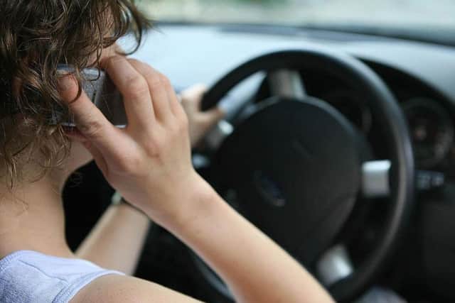 Driving while on the phone will be one of the offences targeted Picture Niall Carson/PA Wire