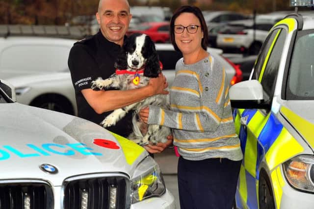 Inspector Gary Jackson with Michelle Sutherland and her medical assistance dog Clive.