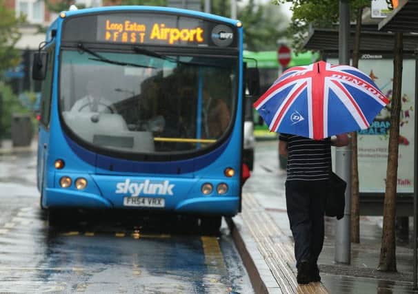A man in Nottingham runs through the rain to catch the bus to the East Midlands Airport. Picture:

Tom Maddick /SWNS