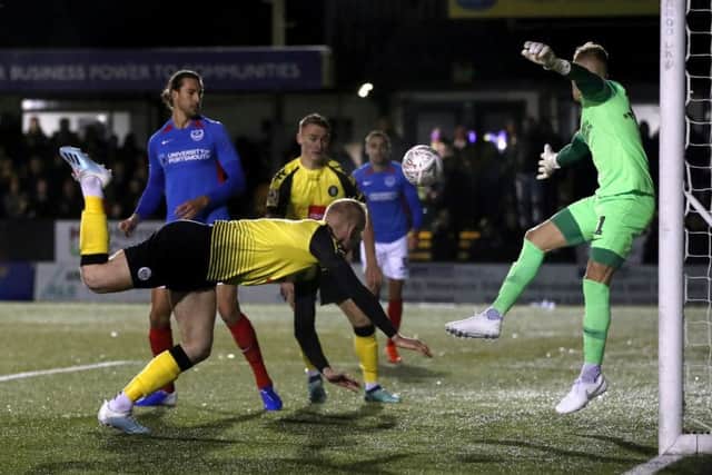 Harrogate Town's Mark Beck scores his side's goal, to give the hosts a seventh-minute lead against Portsmouth. Picture: Martin Rickett/PA