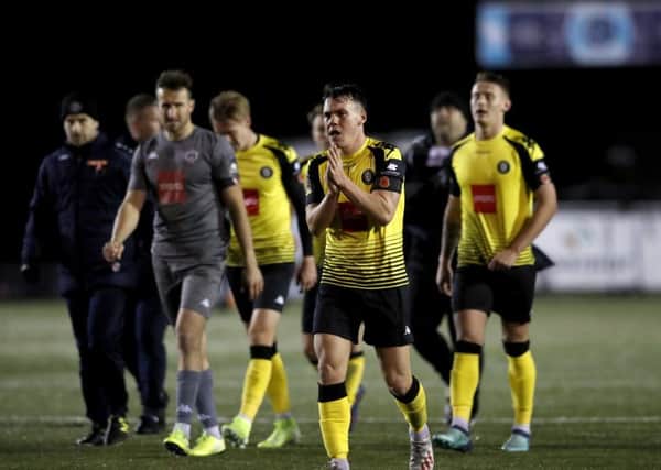 Harrogate Town playersshow their disappointment as they leave the pitch after the final whistle, losing 2-1 to League One Portsmouth in the first round of the FA Cup. Picture: Martin Rickett/PA