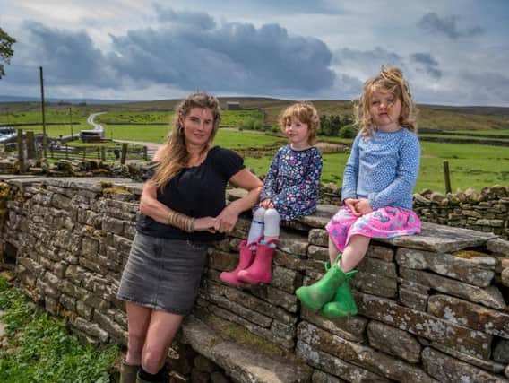 Amanda Owen, the Yorkshire Shepherdess, of Ravenseat Farm, North Yorkshire.  with two of her nine children Nancy and Clemmy. Picture: James Hardisty.
