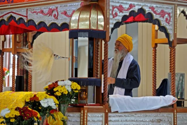Worshipers at the Guru Nanak Gurdwara Sikh Temple, Huddersfield, celebrating the 550th anniversary of their founding guru.  Picture by Tony Johnson