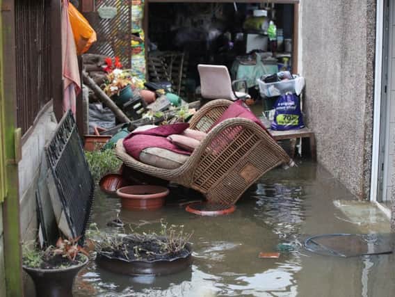 Belongings sit in floodwater outside a house in Fishlake, Doncaster (Danny Lawson / PA).