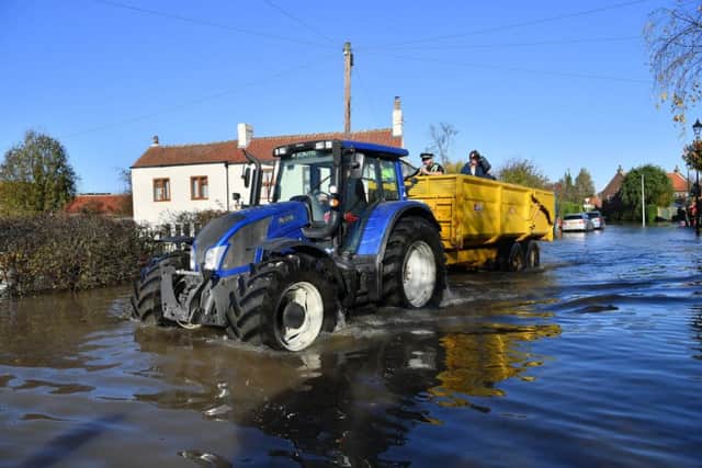 A tractor ferries people around through the floodwater in Fishlake, Doncaster. PIcture: Ben Birchall/PA Wire