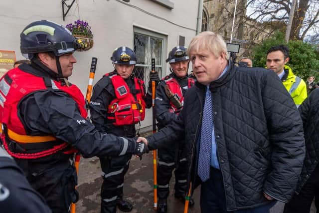 The prime minister Boris Johnson, arriving at St Cuthbert's Church, Fishlake, near Doncaster, chatting Yorkshire and Humber Regional Marine Underwater Search Unit. Photo: JPI Media