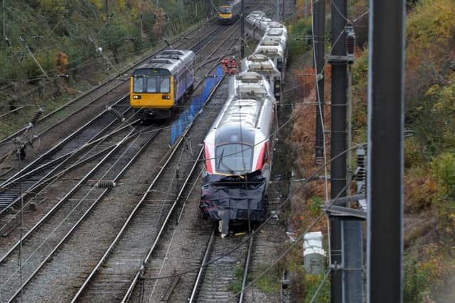 Trains pass the damaged Azuma at Neville Hill this morning