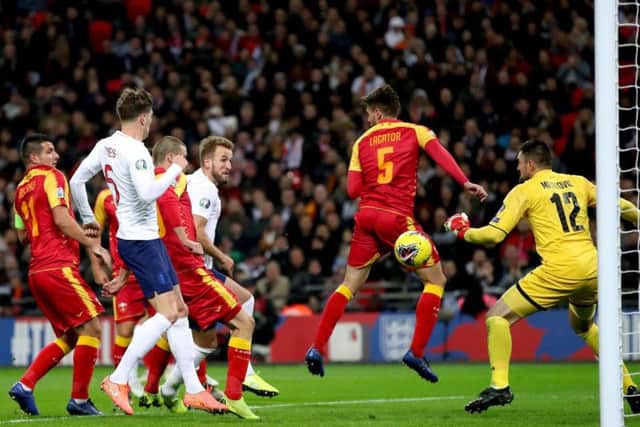 Harry Kane heads the first of his three goals in England's 7-0 Euro 2020 qualifying win at home to Montenegro