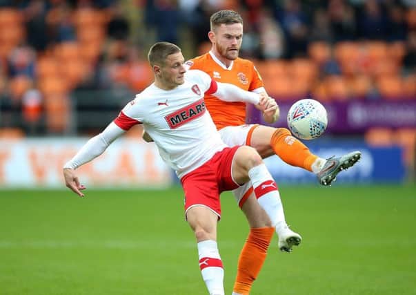Blackpool's Ollie Turton (right) and Rotherham United's Ben Wiles battle for the ball.