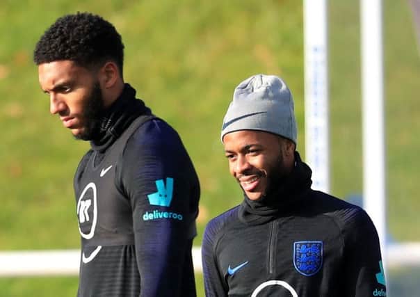 WATER UNDER THE BRIDGE: England's Joe Gomez (left) and Raheem Sterling during training at St George's Park. Picture: Mike Egerton/PA