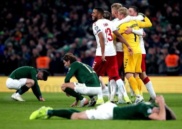 Republic of Ireland's Jeff Hendrick (centre left) appears dejected as Denmark's Kasper Schmeichel (1) and Mathias Jorgensen (13) celebrate victory with team-mates after the UEFA Euro 2020 Qualifying match at the Aviva Stadium, Dublin.(Picture: PA).