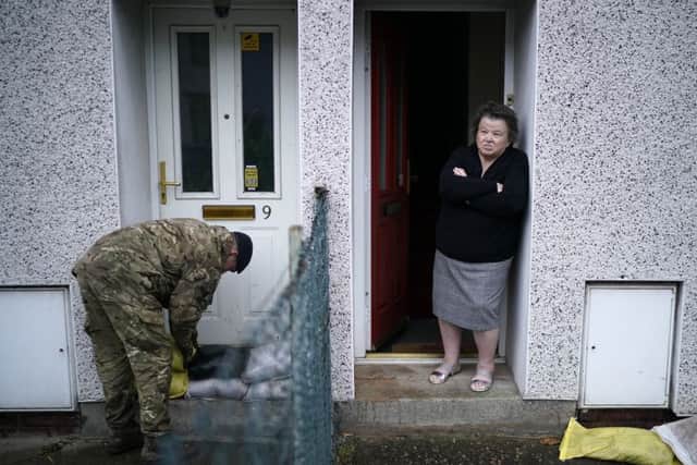 Residents look on as soldiers come to the aid of flood-stricken homes in Doncaster.