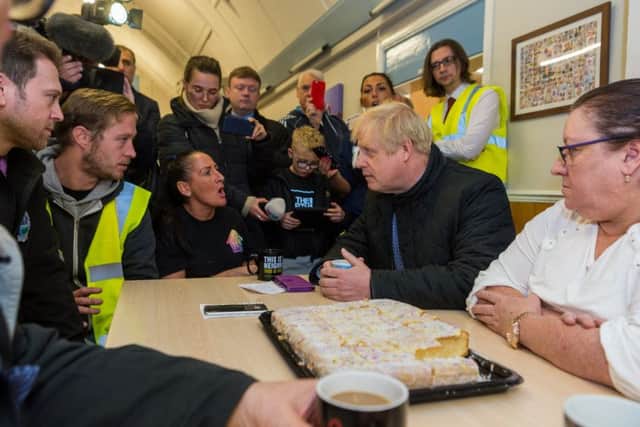 A photograph by James Hardisty of The Yorkshire Post showing Boris Johnson with flooding victims in Doncaster.