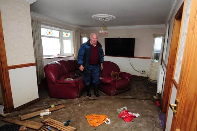John Duckitt pictured inside his flooded house on Trundle Lane, Fishlake. Photo: Simon Hulme