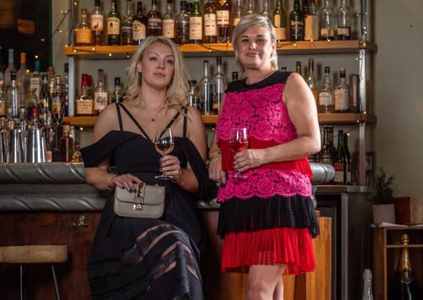 In the bar at Hotel du Vin in Harrogate, wearing pre-owned fashion by The Pod, Alex, left, wears: Off shoulder dress, £160, Self Portrait; clutch bag, £150, Valentino.
Cath wears: Lace tiered dress, £180, Philosophy; shoes, £80, Aquazurra
. Picture James Hardisty.