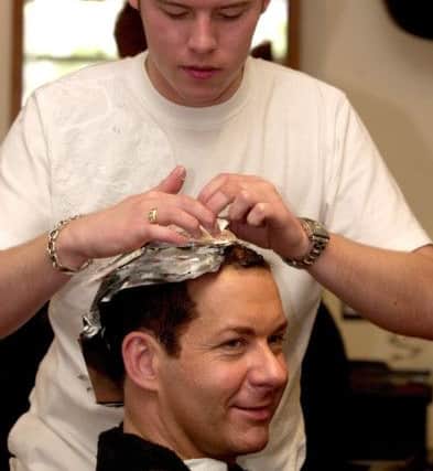 Robert Eaton in 2002, creating a new look for TV floral artist Carl Wilde at Russell Eaton's Barnsley salon.  Picture Chris Lawton