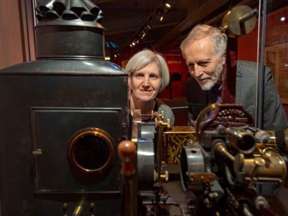 Exhibition curators Toni Booth and Professor Ian Christie, with a 1906 Reliance Animatograph Patent Projector by Robert Paul. Picture: Bruce Rollinson.
