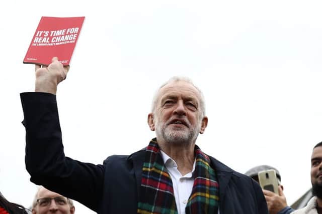 Labour leader Jeremy Corbyn with his party's manifesto.