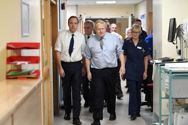 Prime Minister Boris Johnson (centre) with Health Secretary Matt Hancock (left) during a visit to Bassetlaw District General Hospital before Friday night's BBC Question Time special in Sheffield.