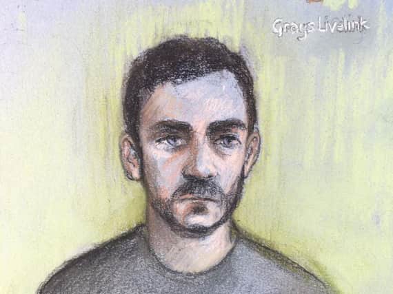 Court artist file sketch by Elizabeth Cook of lorry driver Maurice Robinson, 25, appearing by video-link at Chelmsford Magistrates' Court, Essex. Robinson, who was allegedly part of a global smuggling ring, is charged with the manslaughter of a group of men, women and children found dead in a refrigerated trailer and is due to appear at the court by video link on Monday to enter pleas.Photo credit: Elizabeth Cook/PA Wire
