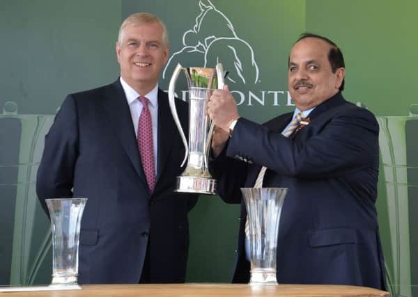 The Duke of York presents the trophy to the owner of Postponed, Sheikh Mohammed Obaid Al Maktoum, after winning the Juddmonte International Stakes during day one of the 2016 Yorkshire Ebor Festival at York Racecourse.