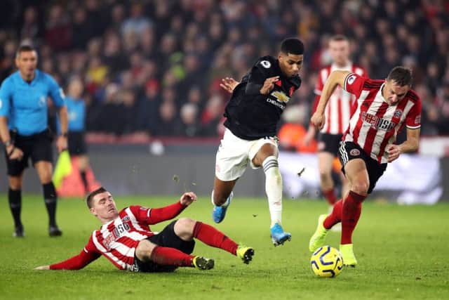 In pursuit: Phil Jagielka, right, enjoyed his tussle with Manchester United's Marcus Rashford.
