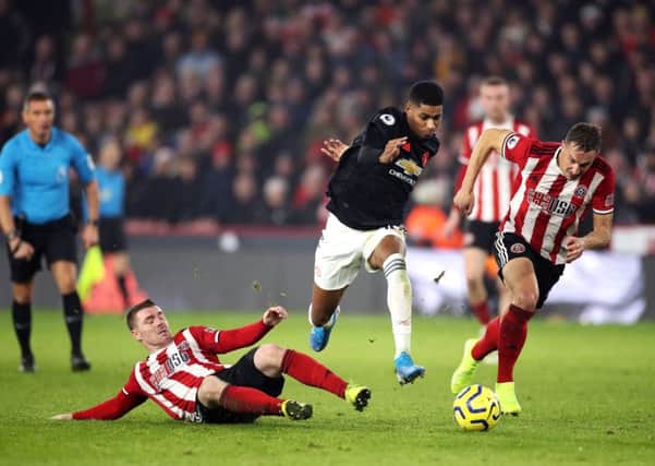 In pursuit: Phil Jagielka, right, enjoyed his tussle with Manchester United's Marcus Rashford.