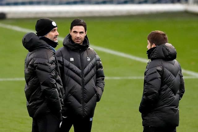 Manchester City manager Pep Guardiola (left) with assistant Mikel Arteta (centre). Picture: Martin Rickett/PA