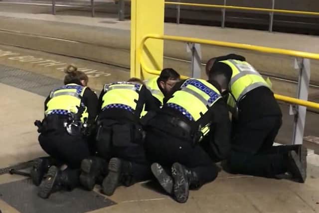Police restraining a man after he stabbed three people at Victoria Station in Manchester. Mahdi Mohamud, 26, has pleaded guilty at Manchester Crown Court to a terrorism offence and three counts of attempted murder after the knife attack last New Year's Eve