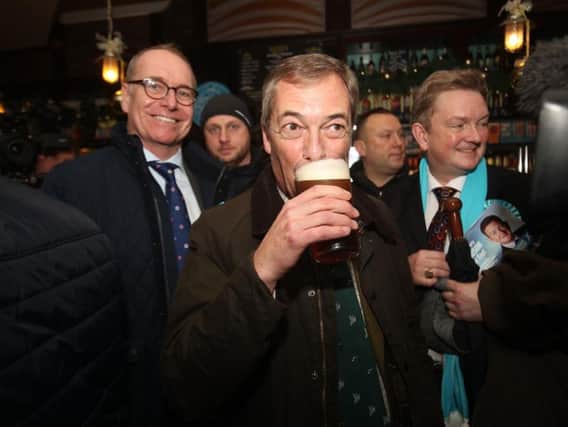 Brexit Party leader Nigel Farage drinks a pint in the Silkstone Inn, Barnsley, during the General Election. Photo credit: Danny Lawson/PA Wire