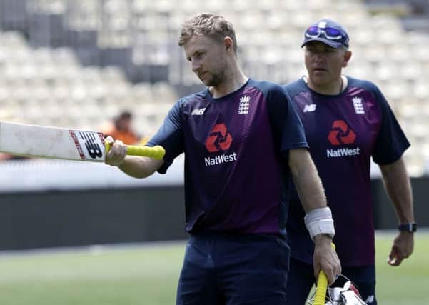 Ready to hit back: England's Joe Root gestures with his bat as coach Chris Silverwood watches.