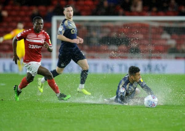 Barnsley's Jacob Brown sent tumbling by Boro's Marc Bola in terrible conditions. (Picture: Tony Johnson)
