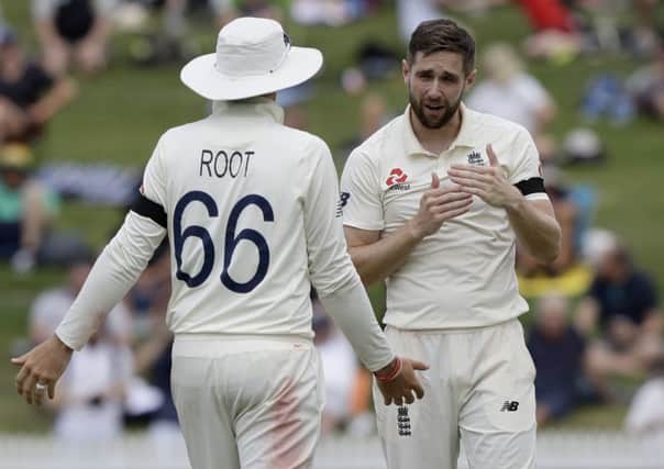 England's Chris Woakes, right, gestures to his captain Joe Root to appeal a not out decision from the umpire during play on day one of the second cricket test between England and New Zealand at Seddon Park in Hamilton .(AP Photo/Mark Baker)