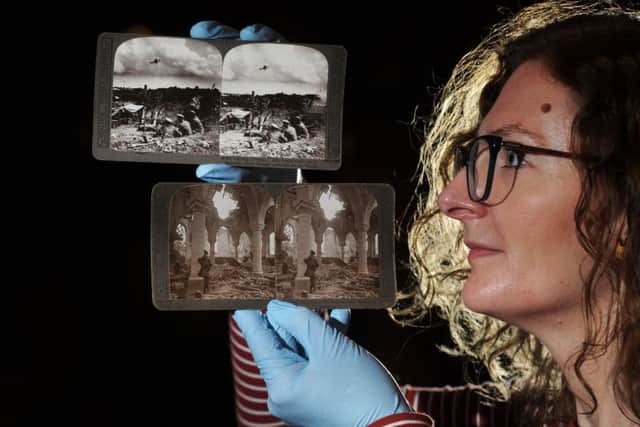 Leeds artist Helen Dryden with original First World War stereogram photographs from the Leeds City Museum collection. 
Helen has worked with a small group of volunteers and has used the historic photos taken on the front lines To create moving 3D images. 
Picture: Tony Johnson