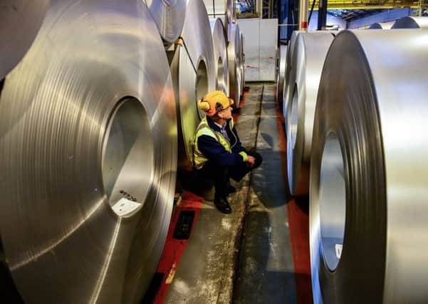 A worker inspecting rolls of steel. Yorkshire manufacturers are continuing to see mixed trading conditions ahead of the new year as research shows the impact of political uncertainty dragging on.  Photo: Ben Birchall/PA Wire