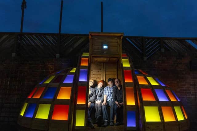 Artist from the Awekids Collective with part of their "Garden of Light" installation that has been unveiled in the garden space of the Cooper Gallery in Barnsley, South Yorkshire. Picture Scott Merrylees