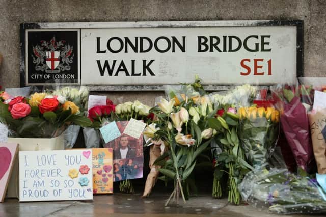 Floral tributes for victims of the terrorist attack, including Jack Merritt, left on London Bridge in central London. Credit: Yui Mok/PA Wire