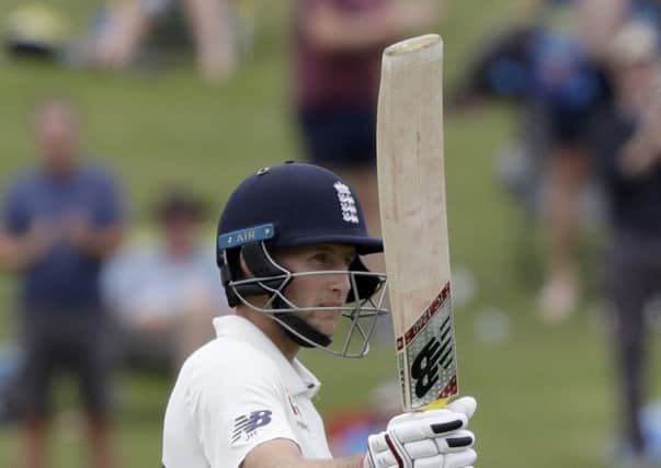 England's Joe Root gestures with his bat as he reaches 150 runs on day four of the second cricket test between England and New Zealand at Seddon Park in Hamilton, New Zealand (AP Photo/Mark Baker)