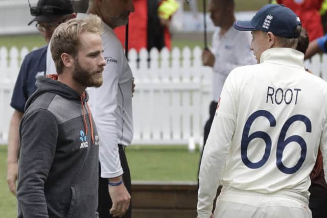 New Zealand captain Kane Williamson, left, and England captain Joe Root talk following play. (AP Photo/Mark Baker)