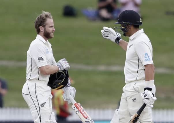 New Zealand's Kane Williamson, left, is congratulated by teammate Ross Taylor after scoring a century against England (AP Photo/Mark Baker)