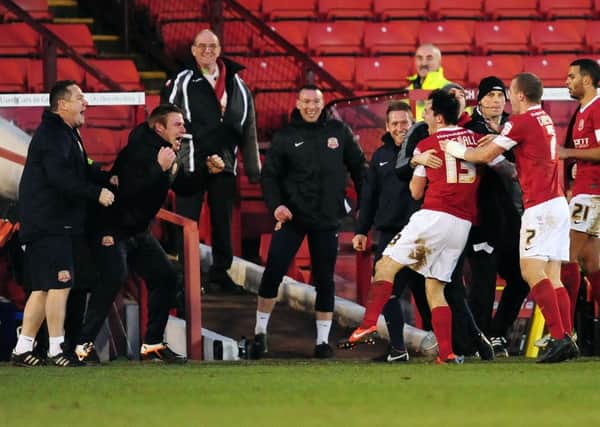 Barnsley's caretaker manager David Flitcroft celebrates with Chris Dagnall after he scored his side's goal.