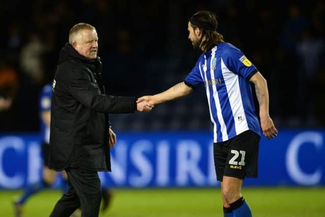 All square Owls George Boyd with Sheffield United boss Chris Wilder shakes hands with Sheffield Wednesday's George Boyd last season . Picture: Steve Ellis