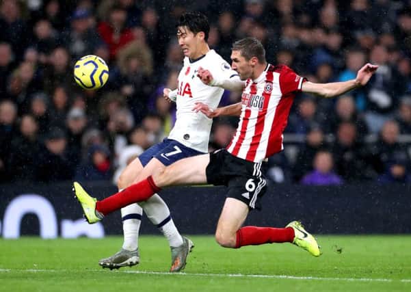 Tottenham Hotspur's Son Heung-min (left) and Sheffield United's Chris Basham battle for the ball. Picture: Bradley Collyer/PA